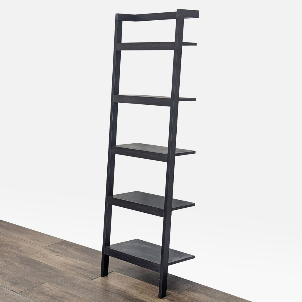 2. Angled side view of a Crate & Barrel mahogany bookshelf in dark mocha finish with five open shelves.