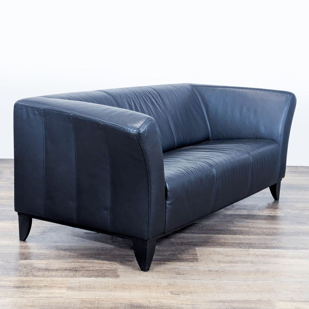 3. Angled perspective of a 3-seat IKEA leather sofa, showing flared arms and wooden tapered legs.