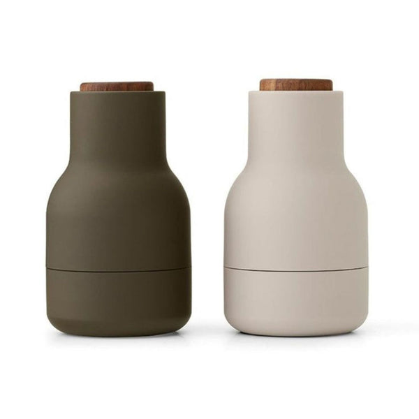 Set of two Audo Copenhagen bottle grinders with walnut lids, featuring a modern, minimalist design.