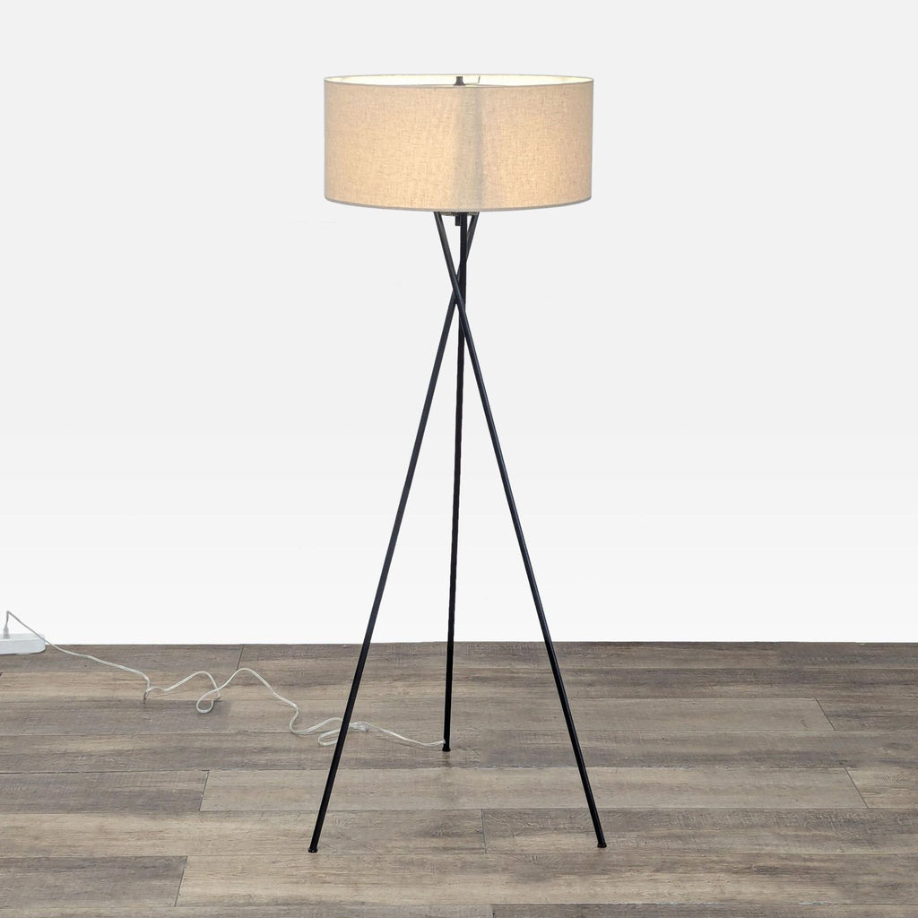 1. West Elm Mid-Century Tripod Floor Lamp with three intersecting black legs and a fabric drum shade, airy and sculptural.