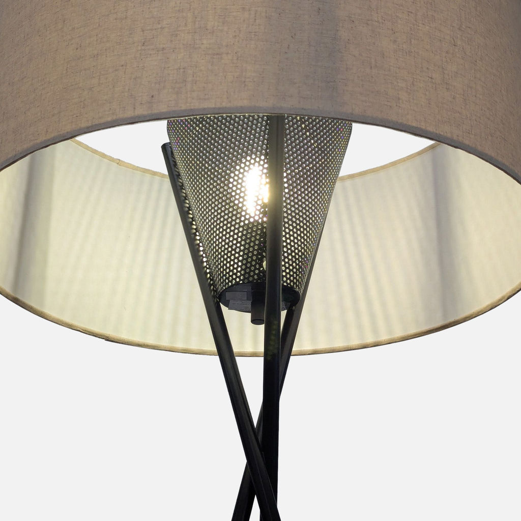 3. Close-up of the West Elm lamp’s black tripod legs and the unique perforated diffuser beneath the drum shade.