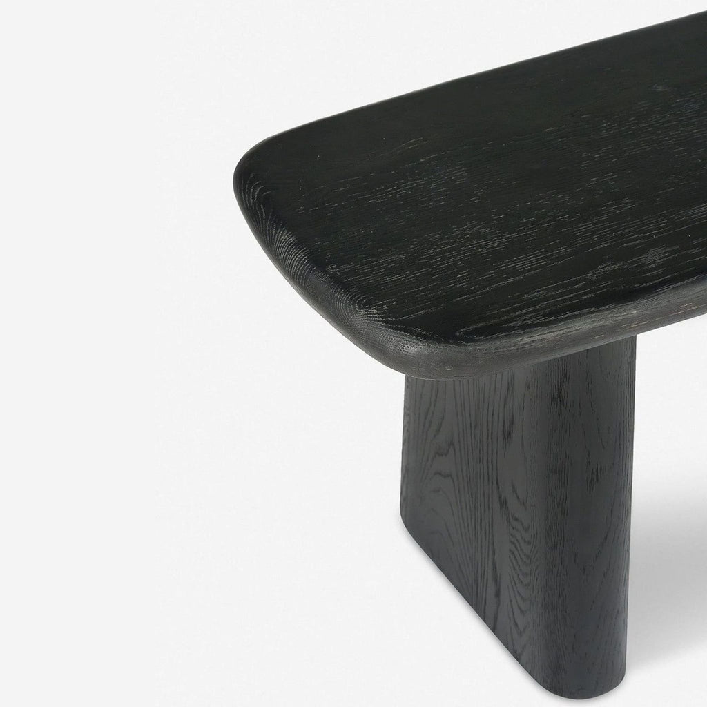 2. Close-up of a charcoal-finished oak bench corner, showing wood texture and smooth, curved edges.