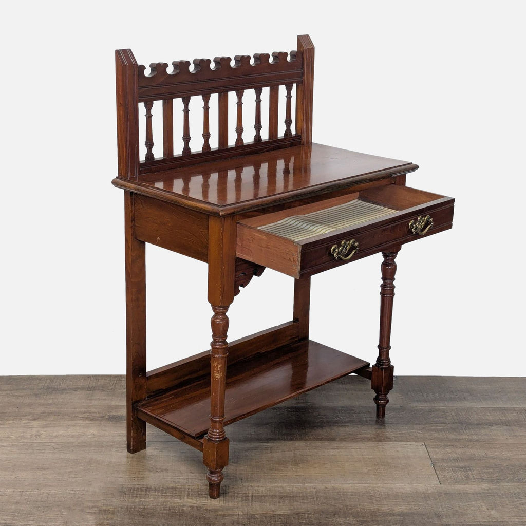 2. Angled view of the Reperch console table, featuring an open drawer with striped lining and wooden shelves.  