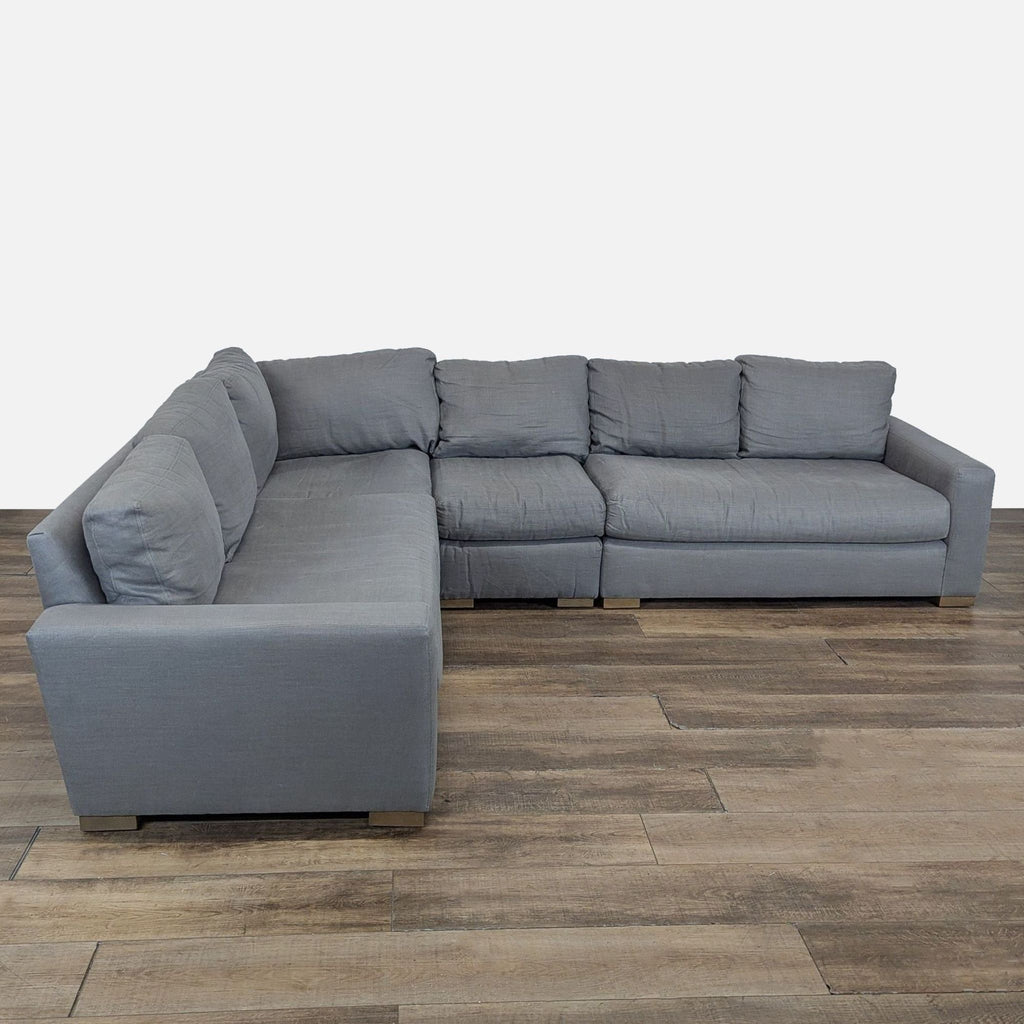 1. Gray Restoration Hardware sectional with wide track arms, plush removable cushions, and wood block feet, front view.