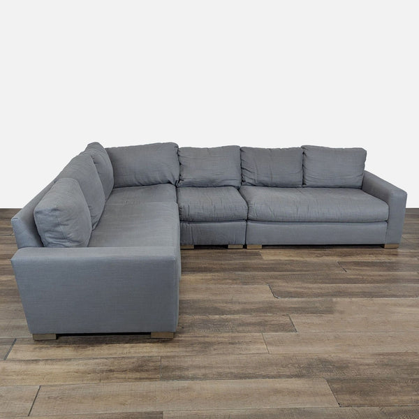 1. Gray Restoration Hardware sectional with wide track arms, plush removable cushions, and wood block feet, front view.