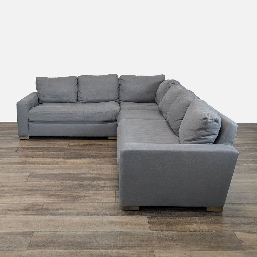 2. Restoration Hardware sectional sofa in gray, shown from an angled side view, featuring wide arms and plush cushions.