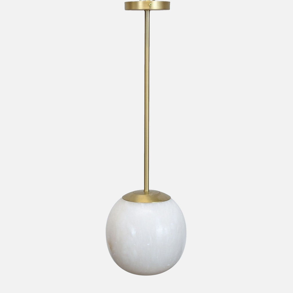 CB2 Savina Pendant light with natural alabaster globe and brass accents, suspended from a brass rod.