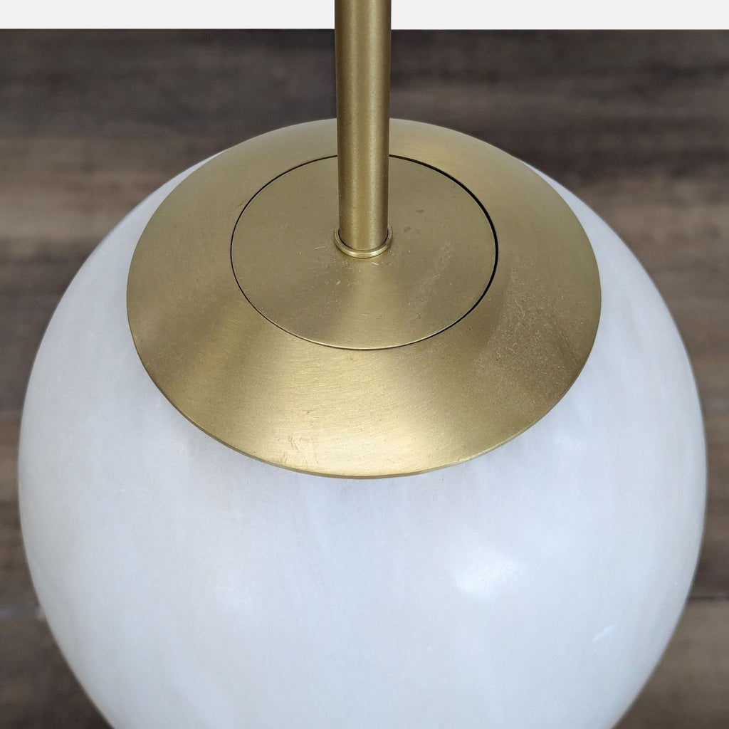 Top view of the CB2 Savina Pendant showing brass accents and alabaster globe in the lighting category.