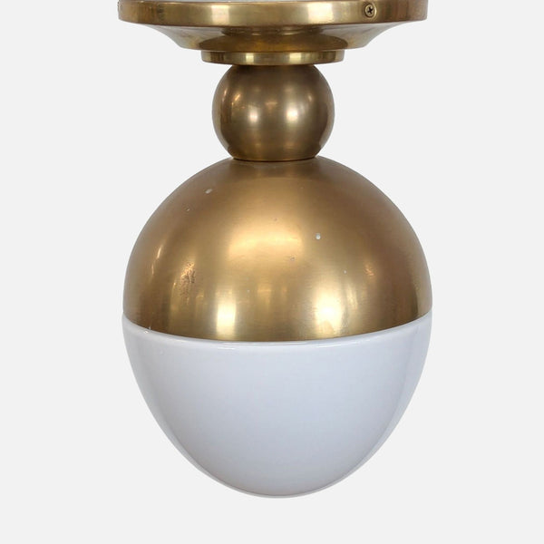 1. Brass ceiling light fixture with an antiqued finish and a rounded glass shade by One Kings Lane.  