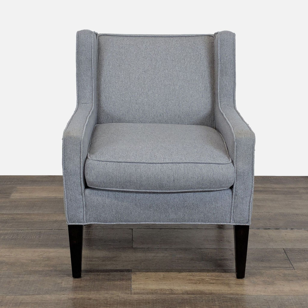 1. Front view of a gray Cypress Furniture lounge armchair with a wingback design and piped seams.