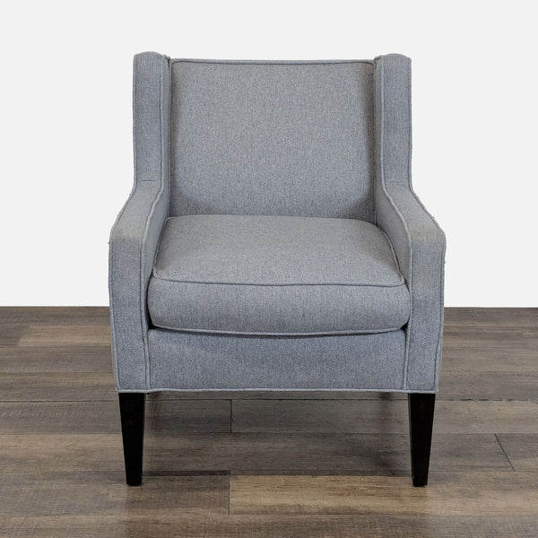 1. Front view of a gray Cypress Furniture lounge armchair with a wingback design and piped seams.