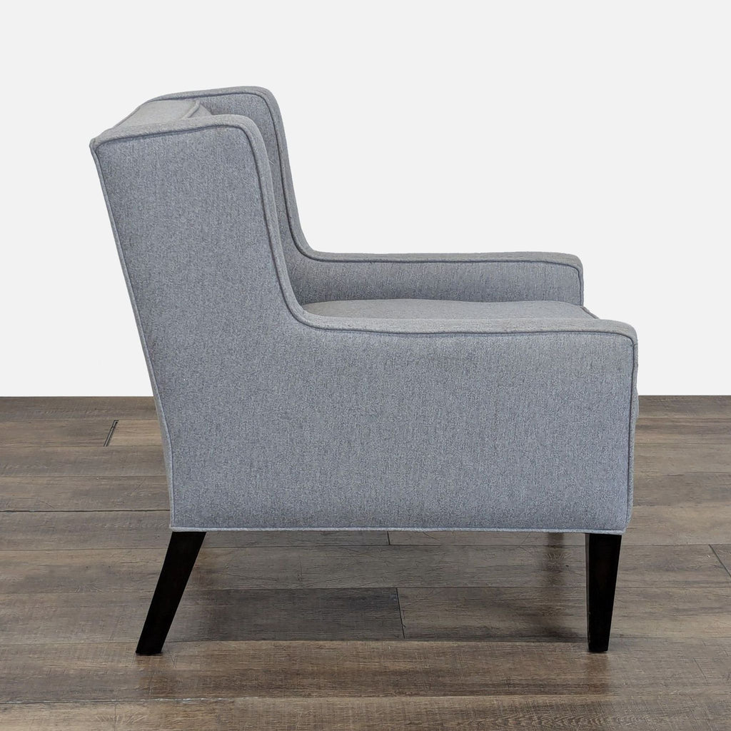 2. Side view of a gray upholstered lounge chair by Cypress Furniture, featuring dark tapered legs.
