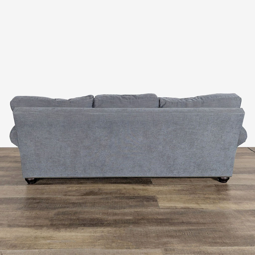 3. Back view of Pottery Barn 3-seat sofa, fabric upholstery with rolled arms and subtle nailhead trim.