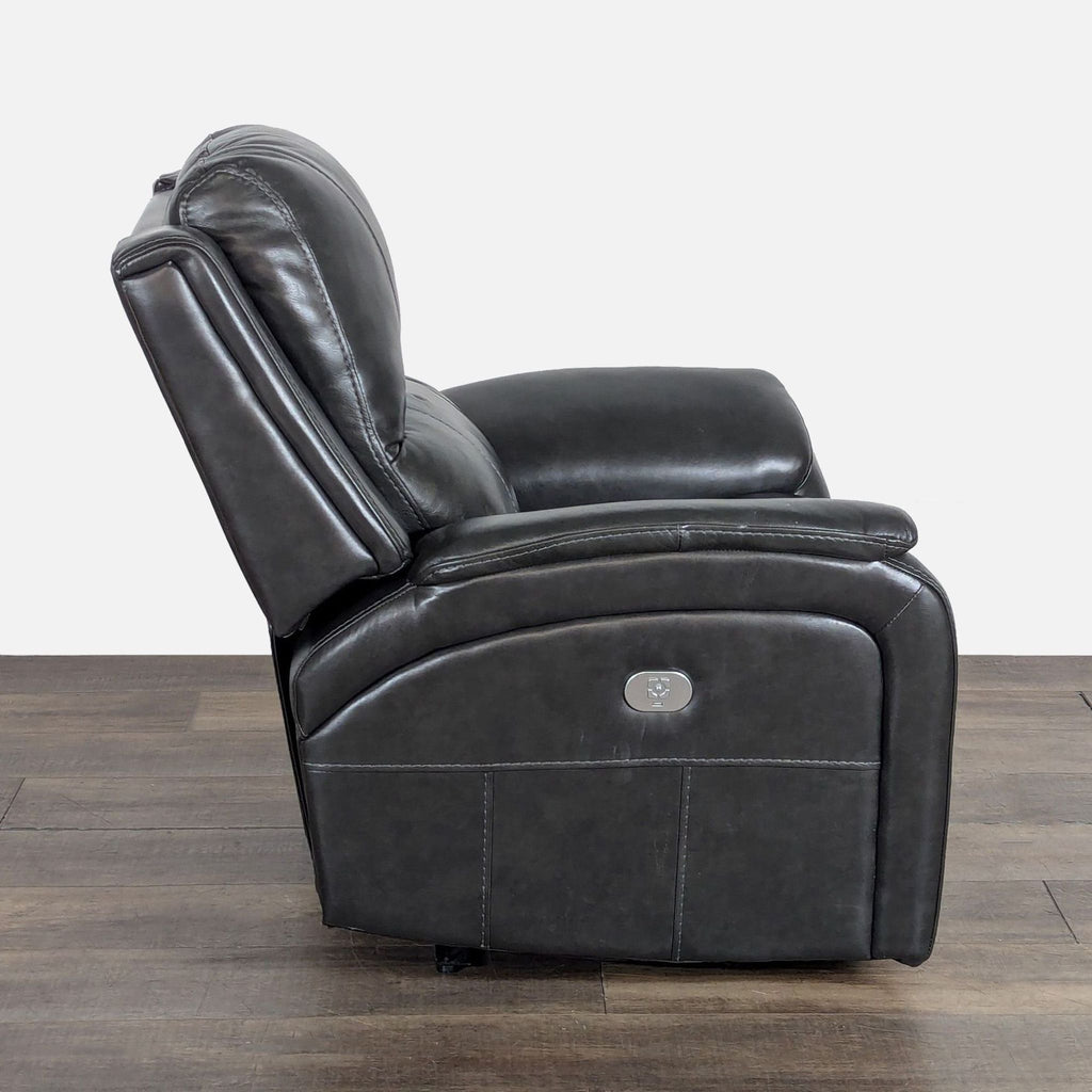 Living Spaces Lounge power recliner in black leather shown from the side with visible control panel.