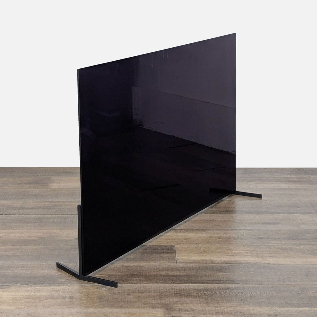 3. Angled side view of a Sony XR-65A95L 65-inch QD-OLED TV showing its ultra-thin profile and minimalist stand.