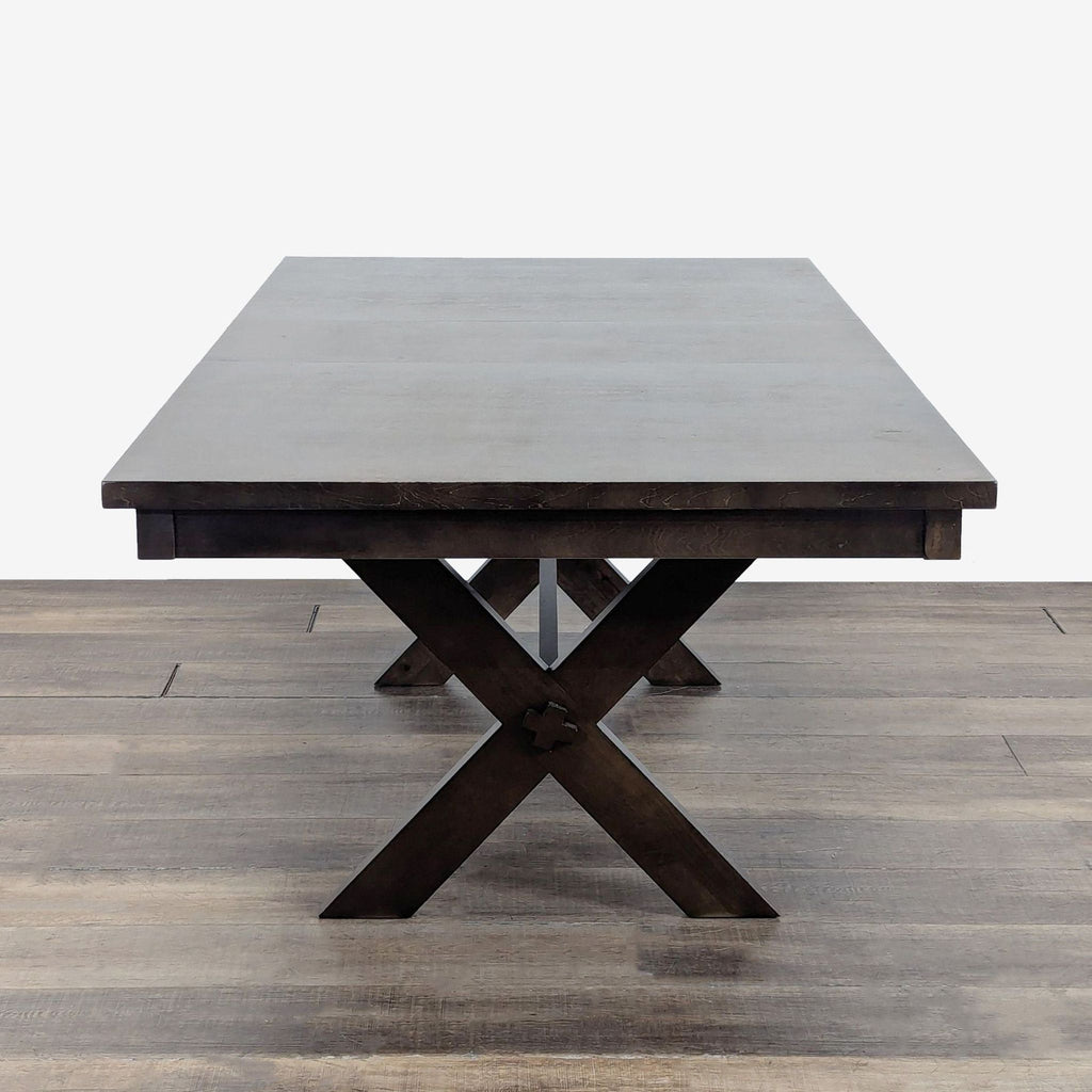 2. Dark wood dining set from Living Spaces viewed from the end, highlighting its X-cross base design.
