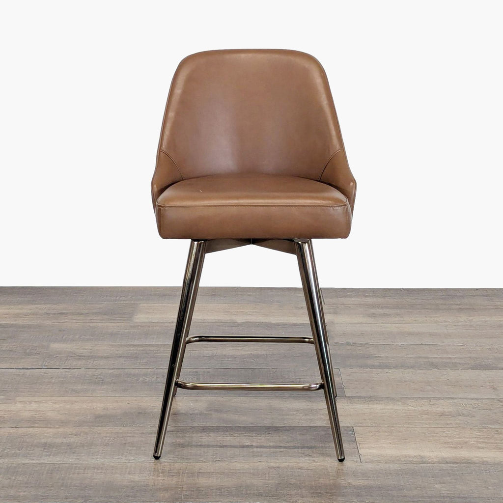 1. West Elm brown leather stool with chrome legs, featuring a curved back and modern design on wood flooring.