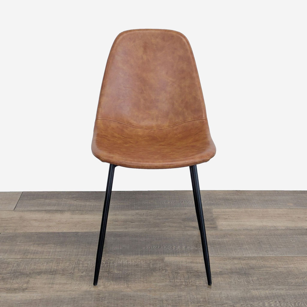 Single brown Reperch dining chair with black legs, centered on a wood floor against a plain background.