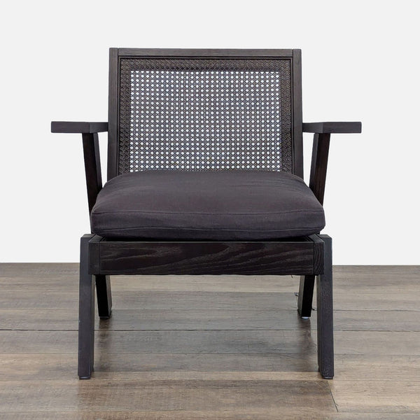 Front view of Crate & Barrel Jeannie Cane Accent Chair with solid oak frame, cane back, and charcoal cushion.