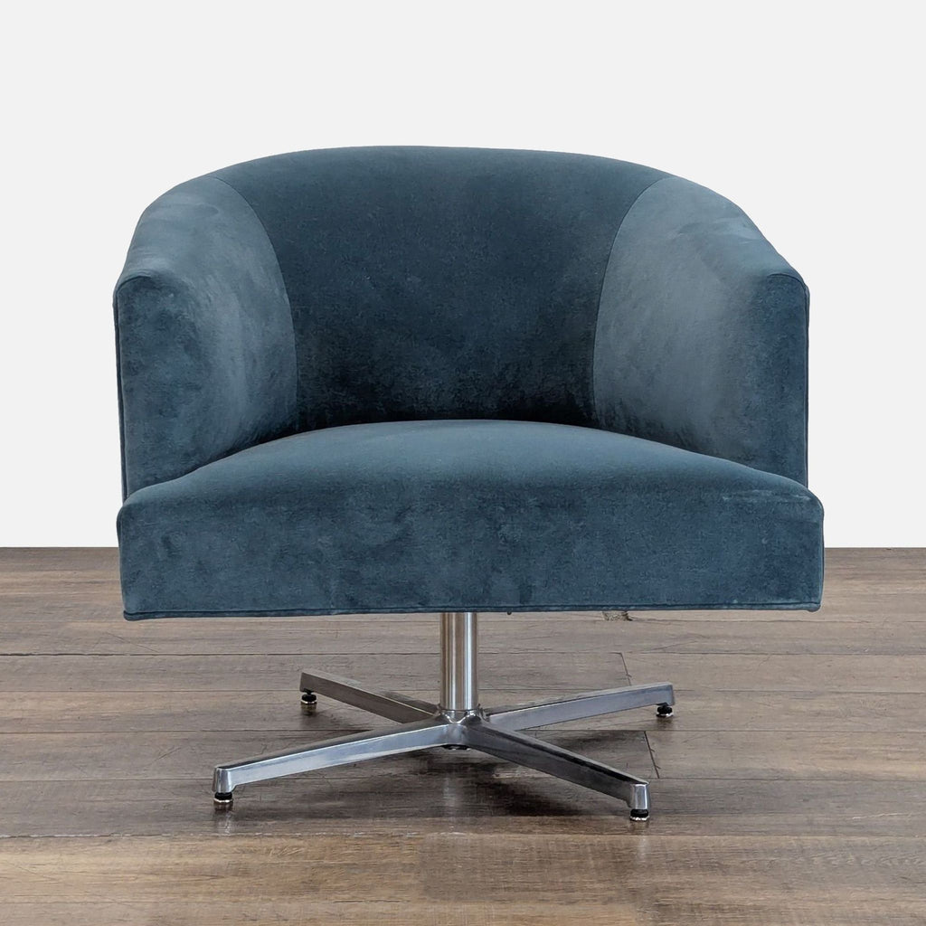 Blue velvet lounge swivel tub chair by Reperch, featuring a steel x-base, shown from the front.  