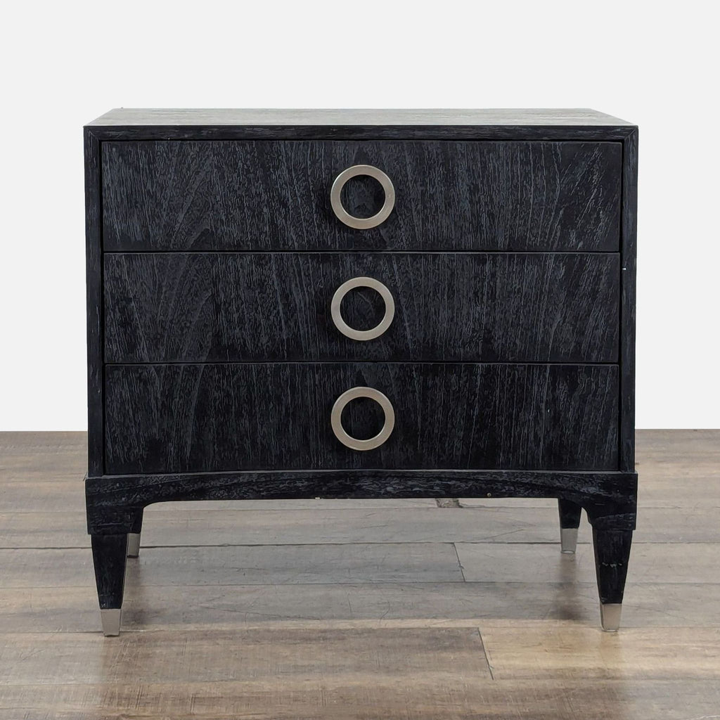 1. Black end table by Brownstone Furniture with three drawers and brushed stainless-steel ring pulls.