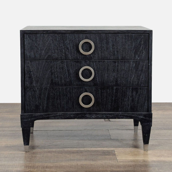 1. Black end table by Brownstone Furniture with three drawers and brushed stainless-steel ring pulls.