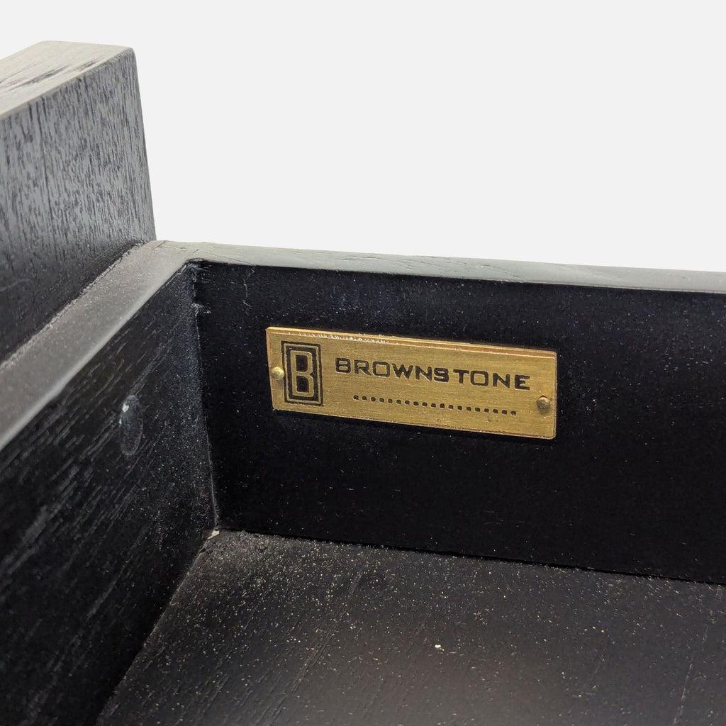 3. Close-up of Brownstone Furniture brand plaque inside the black end table's drawer.
