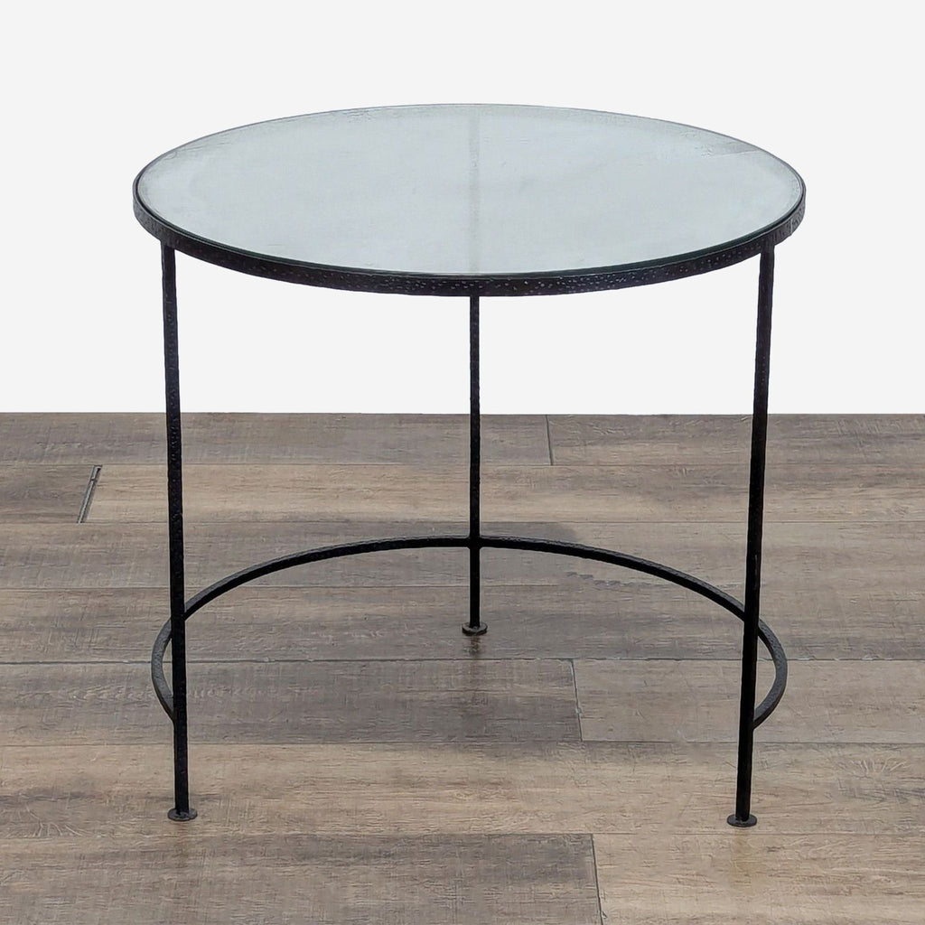 1. Round Reperch side table with a glass top and slim black metal frame, positioned on wooden flooring.