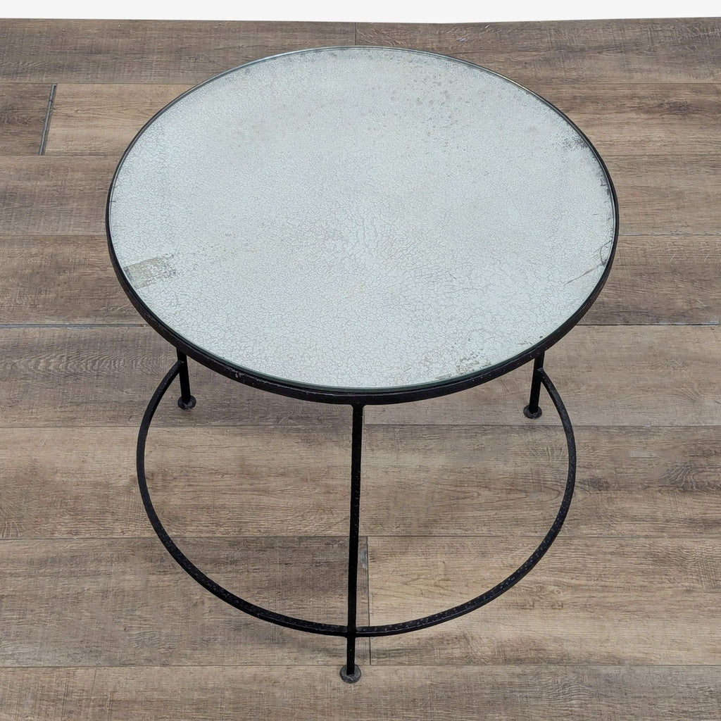 2. Overhead view of a Reperch side table showing a textured, aged glass top with a circular metal base.