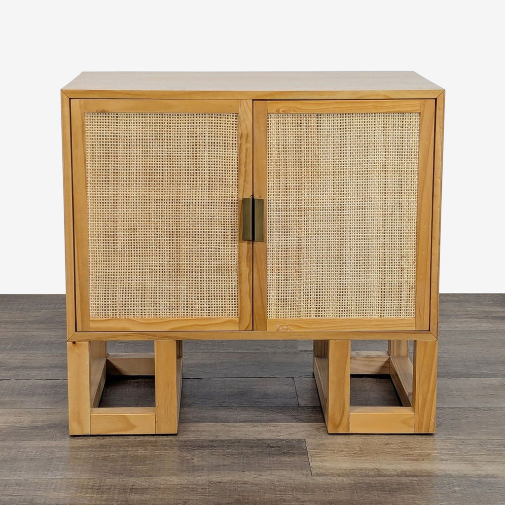 1. Front view of a Reperch cabinet with woven rattan doors and a natural wooden frame on square legs.