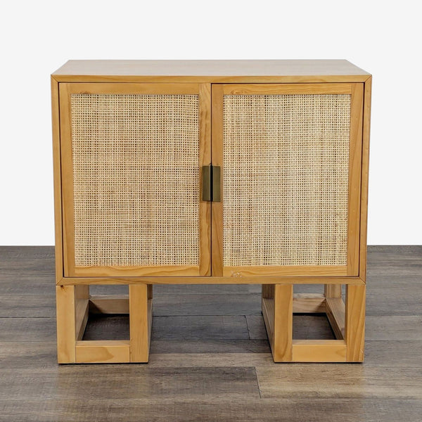1. Reperch cabinet with wood frame, woven front doors, and open square legs on a wood floor, closed view.
