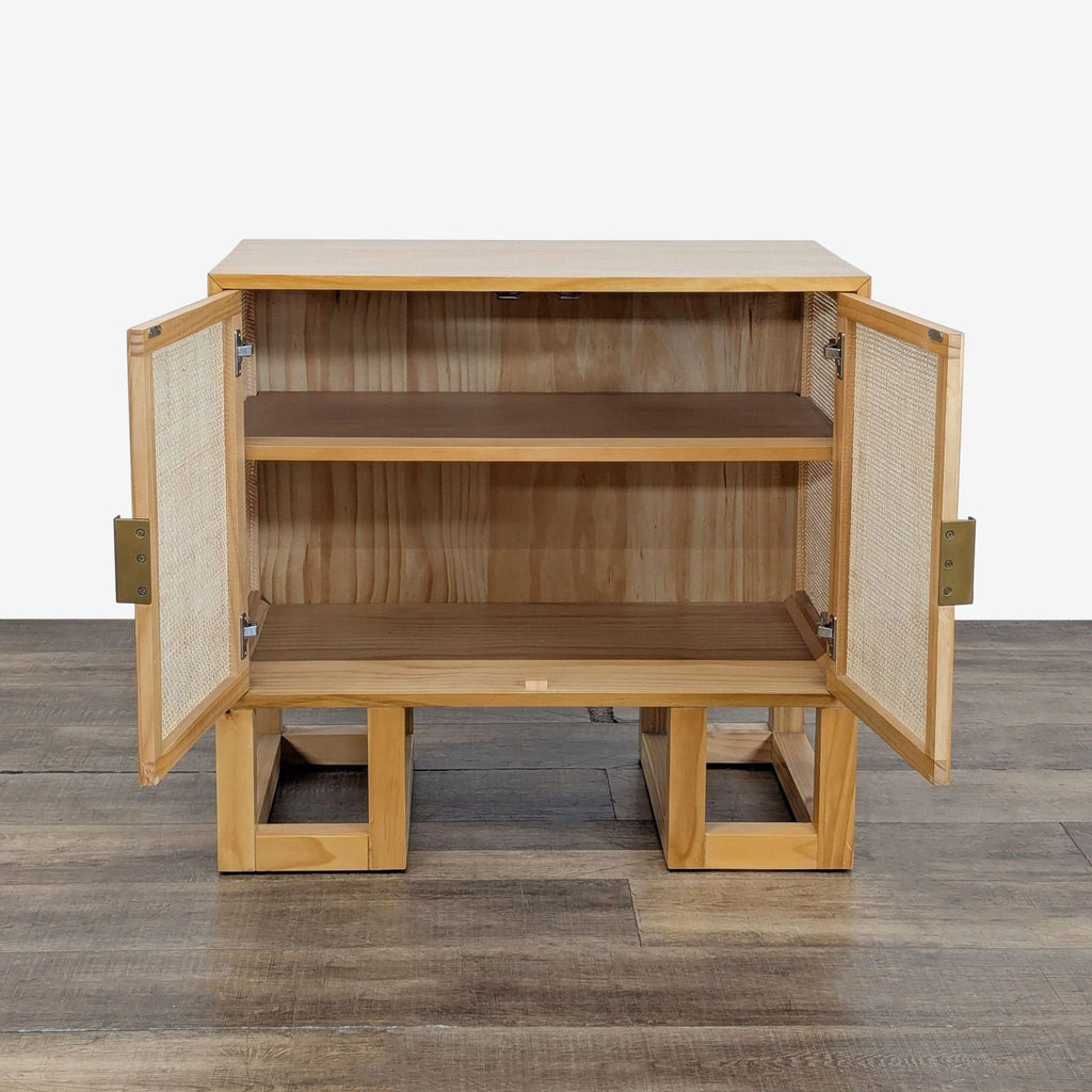 2. Reperch cabinet with doors open, revealing two wooden shelves inside and rattan door detailing.