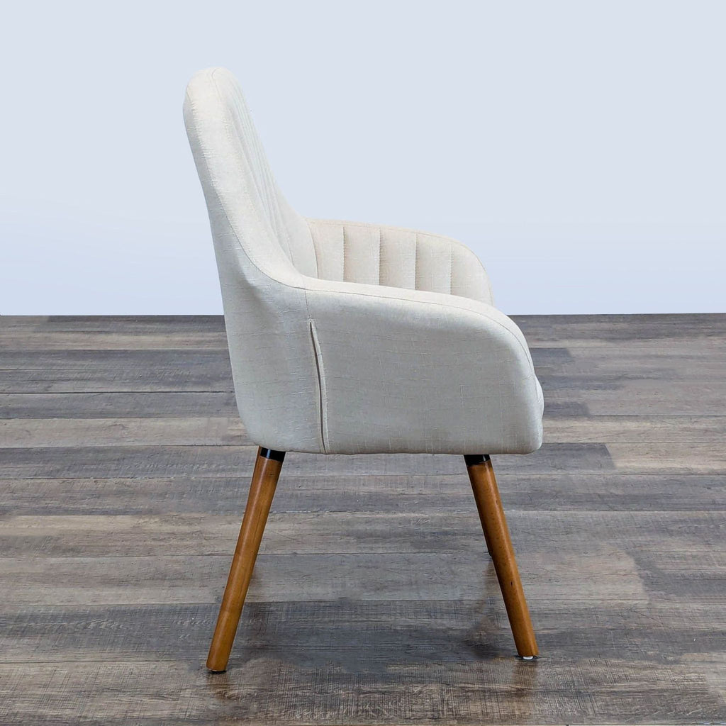 Side view of a Roundhill Furniture lounge chair, showing fabric upholstery, wood legs, and channel tufting.