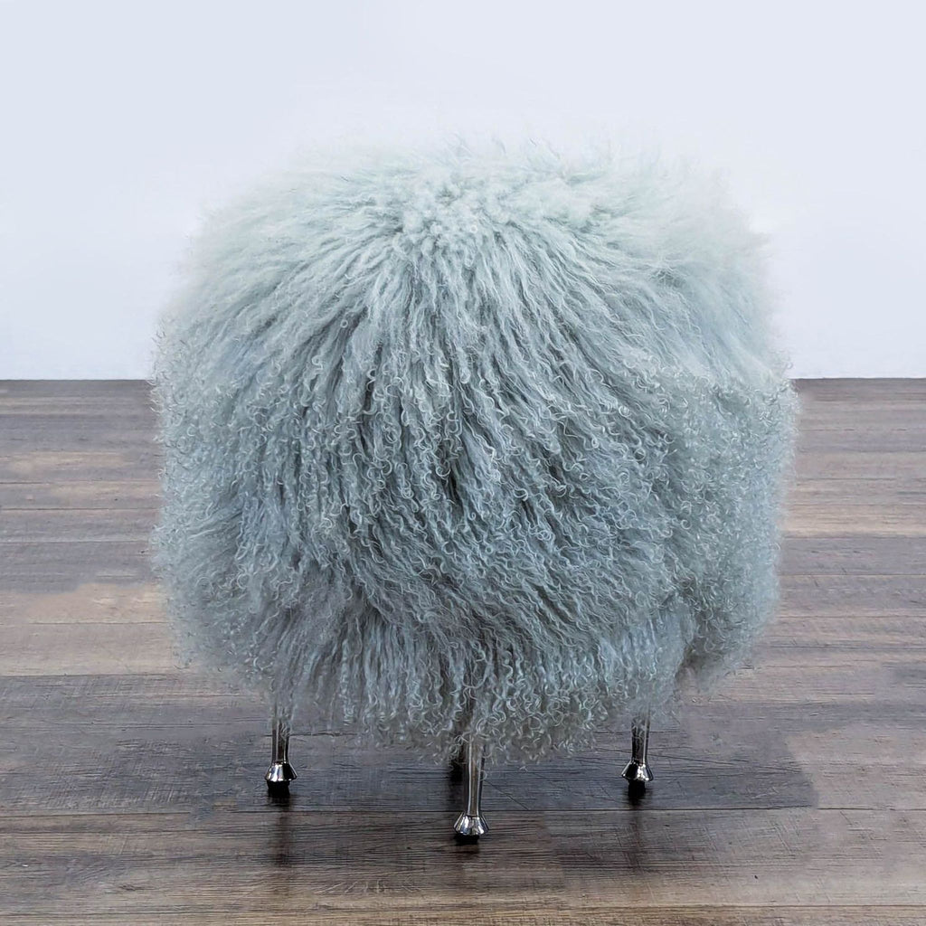 Ivory sheepskin seat with sleek stainless steel legs by Interlude Home.  