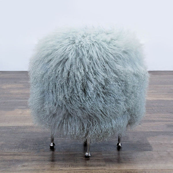 Ivory sheepskin seat with sleek stainless steel legs by Interlude Home.  