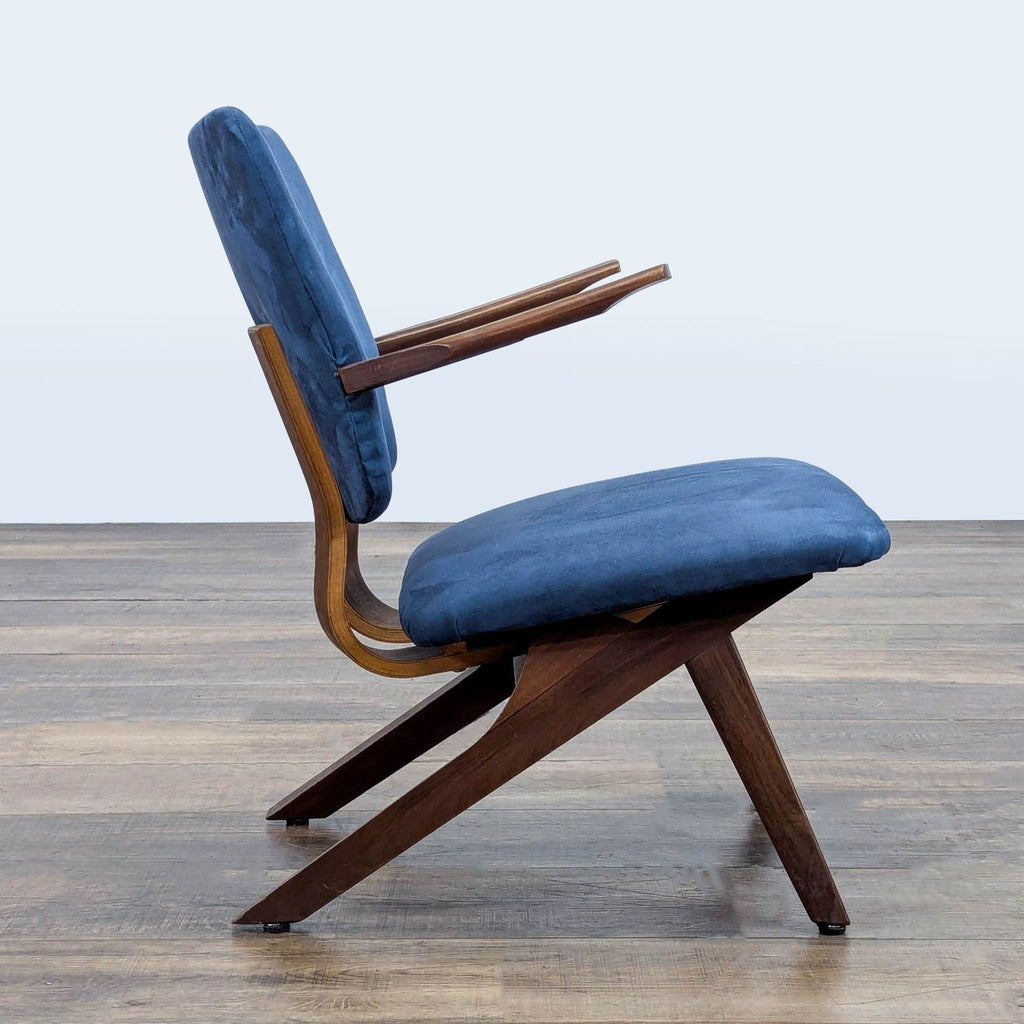 2. Side view of Reperch mid-century lounge chair, featuring angled legs, armrests, and blue upholstered seat and back.  