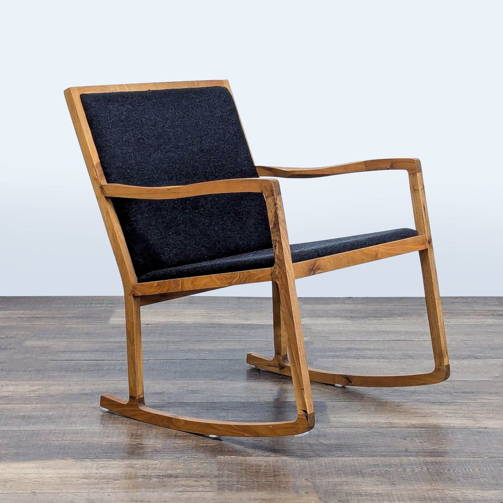 Angled view of H.D. Buttercup lounge chair featuring a walnut wood frame and charcoal black tweed upholstery.
