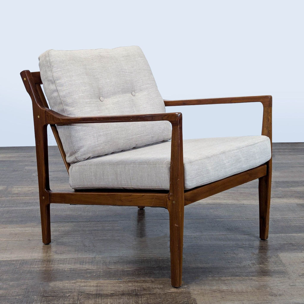 3. Angled view of a Reperch lounge chair featuring a wood frame, upholstered cushions, and slatted back.
