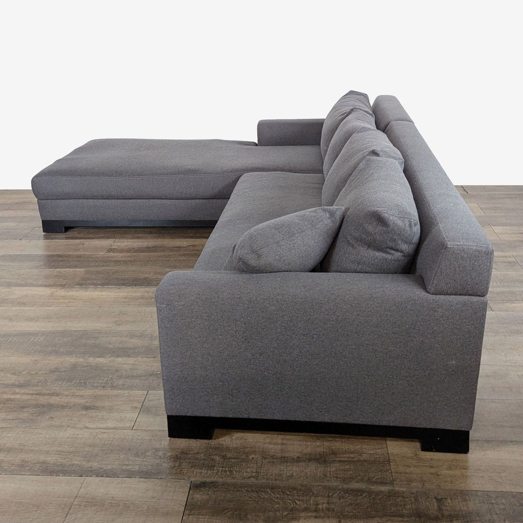2. Side profile view of a gray Fitzgerald sectional sofa with chaise lounge and plush cushions.