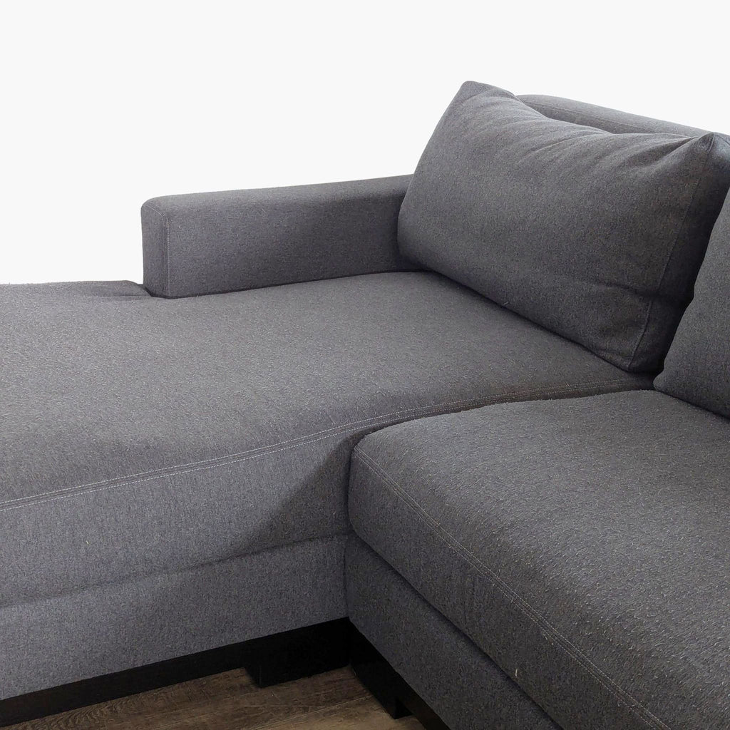 3. Close-up of the corner and armrest of the gray Fitzgerald L-shaped sectional sofa with chaise lounge.