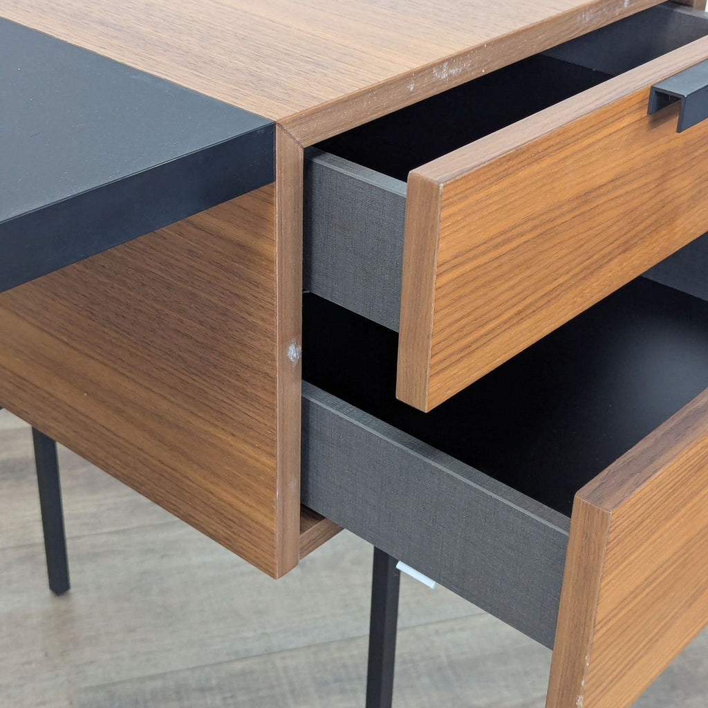 3. Close-up of Ligne Roset desk’s walnut drawers and black scratch-resistant FENIX laminate writing surface.