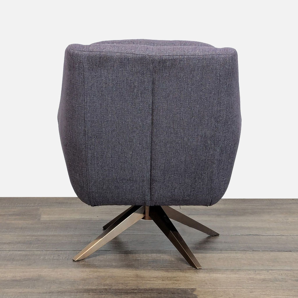 3. Rear view of the Reperch lounge chair, featuring its distinctive fabric and angular pyramidal base design.