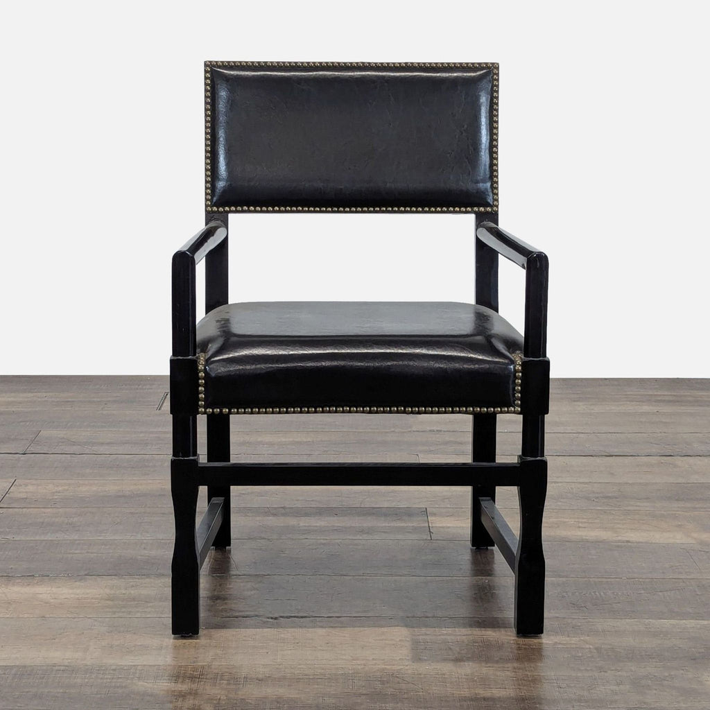 1. Reperch dining chair with wood frame and nailhead trim, upholstered in black, front angle view.