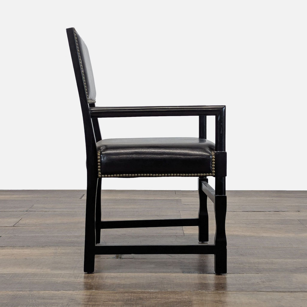 3. Side profile of Reperch dining chair, wood frame and black nailhead trim upholstery on seat and back.
