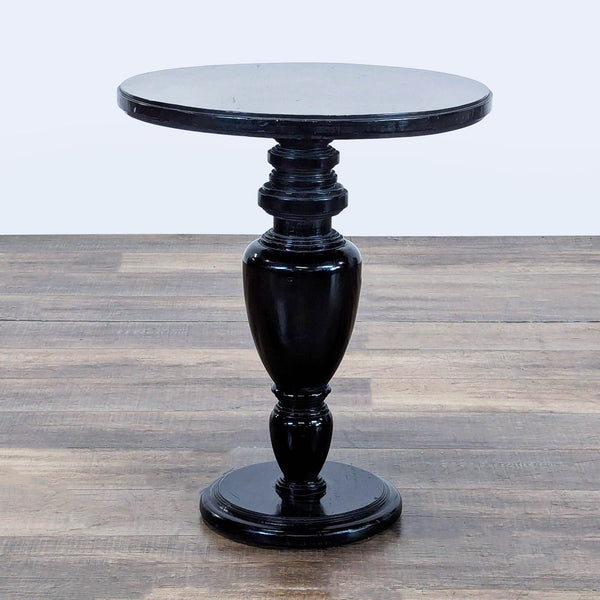 1. Reperch black side table with round top and turned pedestal base, placed on wood flooring.