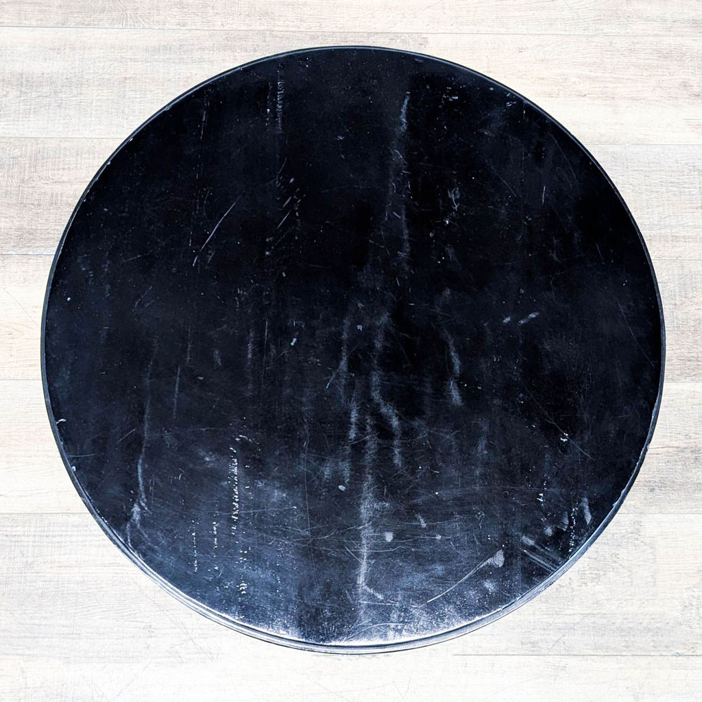3. Top-down view showing the black circular tabletop of a Reperch side and console table.