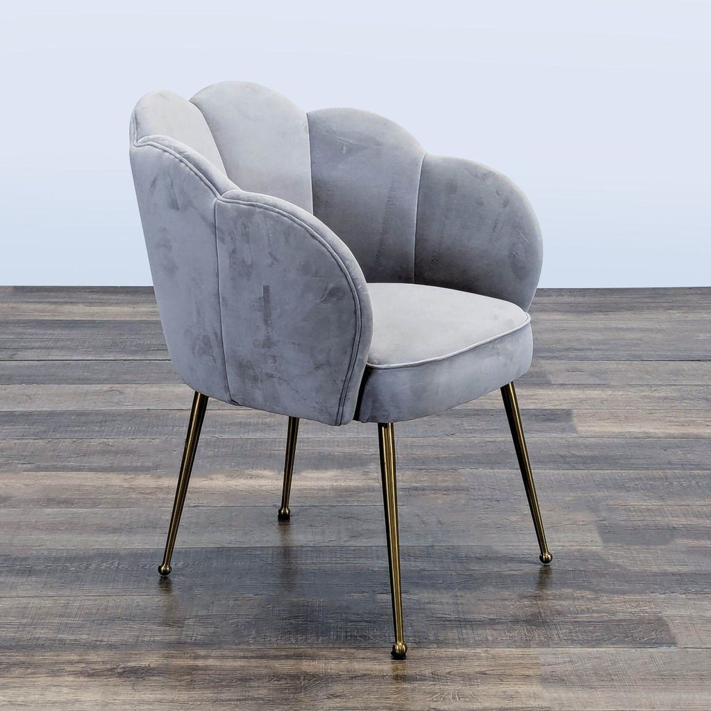Three-quarter view of a scallop-backed velvet chair with gold steel legs from TOV Furniture, category Other.