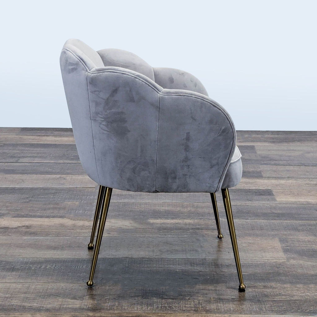 Side angle of a TOV Furniture chair, featuring plush gray velvet and sleek brushed gold legs.  