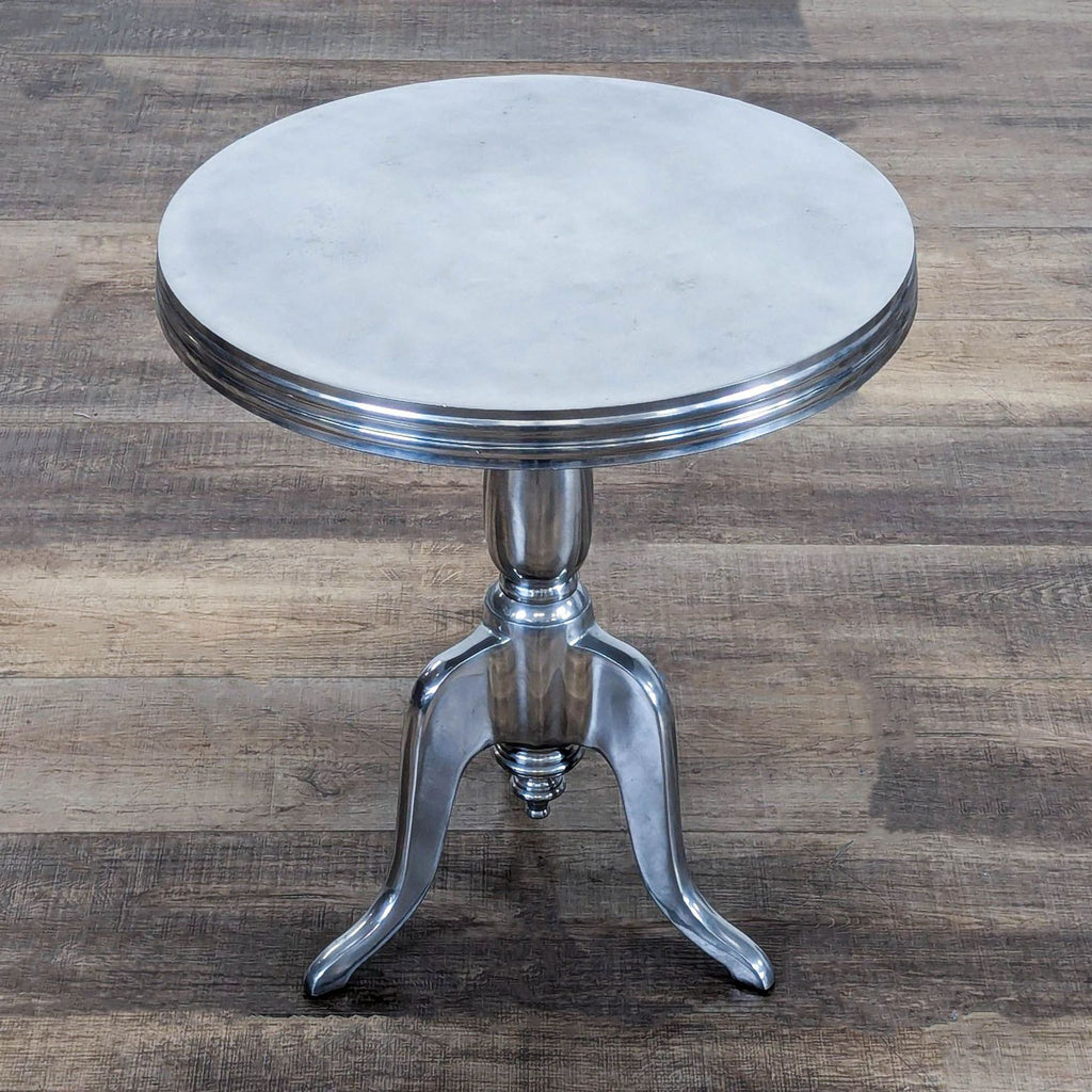 3. Overhead view of a Reperch brand aluminum side table with three legs and a sleek, modern design.