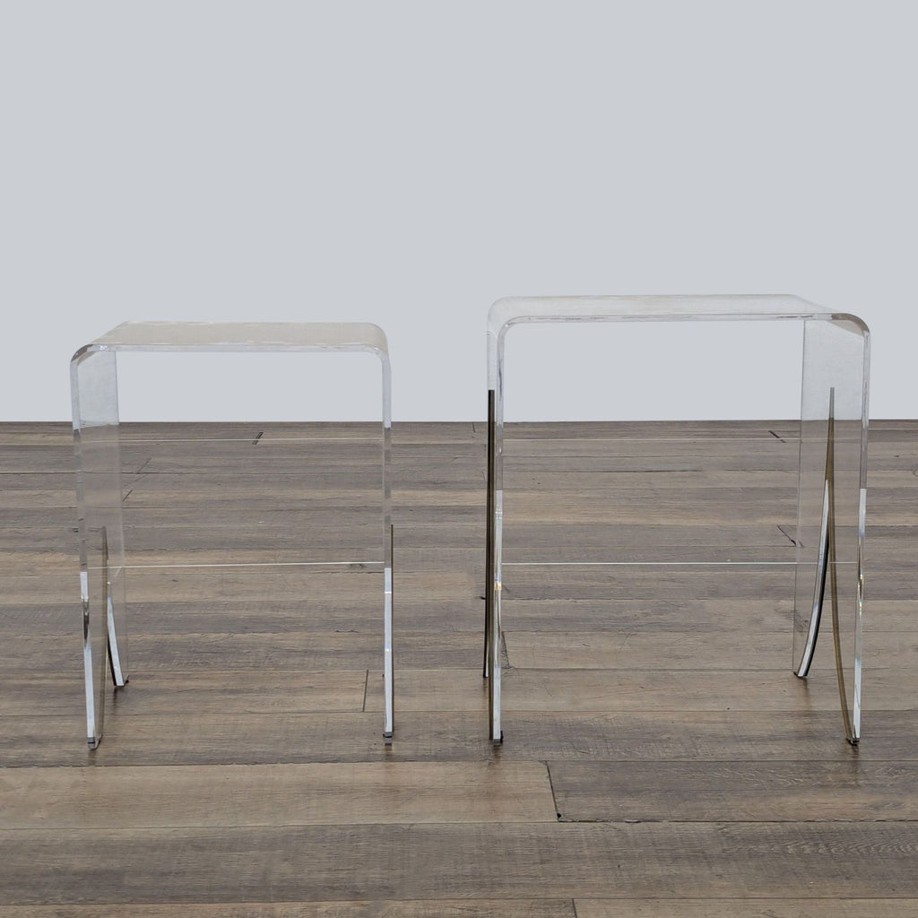 1. Pair of clear acrylic waterfall end tables with antique brass inlay, Gabby Magnolia brand, on wood floor.